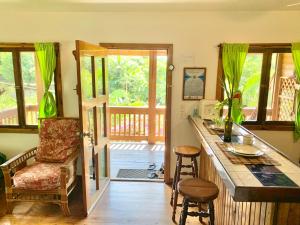 a kitchen with a counter and a bar with stools at Seabreeze Inn in West End