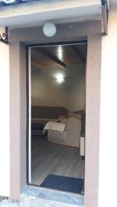 a window into a bedroom with a bed in it at Katun Mokra in Podgorica