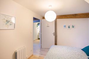 a bedroom with a bed and a hallway at LE LÉONARD Échappée Amboisienne avec sauna partagé in Amboise