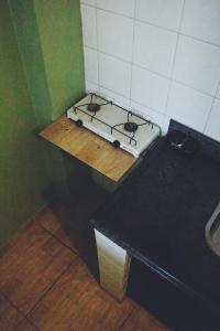 a kitchen with a stove on top of a table at Paradise Hostel e Flats in Itatiaia