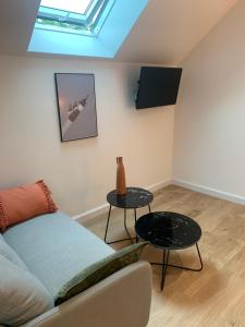 a living room with a couch and a table at Le studio d’Ambre in Chalon-sur-Saône