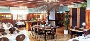 a restaurant with tables and chairs in a room at A l'Arbre Vert in Wintzfelden