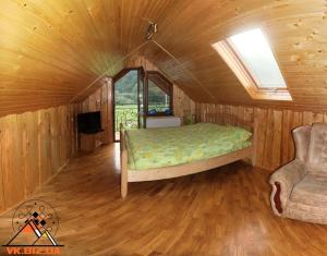 a bedroom with a bed and a couch in a room at Silence in Mykulychyn