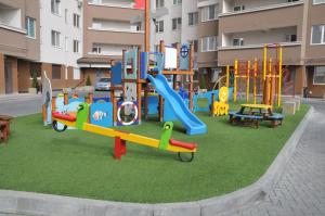 a playground in front of a apartment building at DendrariumParkApartments in Chişinău