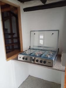 a stove sitting on a counter in a room at Cabañas El Manglar in Las Tunas