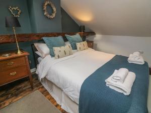 a bedroom with a bed with towels on it at Carwood in Dufton