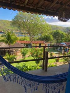 a view of a resort with a hammock at Pousada Trilha do Velho Chico in Piranhas