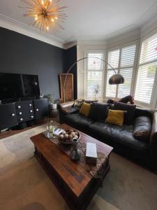 a living room with a couch and a coffee table at Traditional apt close to city centre & Hampden in Glasgow