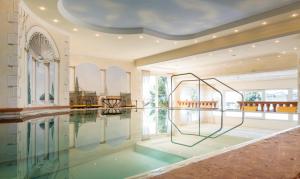a swimming pool with a glass floor in a house at Hotel Jenbacherhof B&B in Jenbach