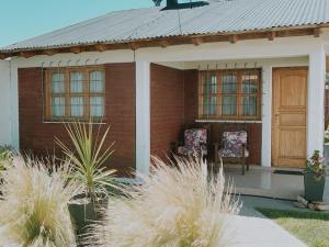 a small house with two chairs on the porch at Casa Meli in San Rafael