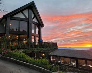 a house with a sunset in the background at Top Cloud Villa in Renai