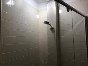 a shower with a shower head in a bathroom at Northlodge Central City Apartments in Perth