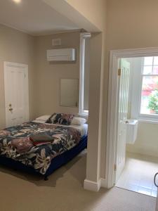 a bedroom with a bed and a window at Northlodge Central City Apartments in Perth