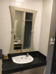 a bathroom with a sink and a mirror at YWCA Hotel Bangkok in Bangkok