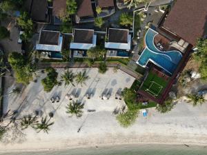 an overhead view of a resort with a swimming pool at The Cabin Beach Resort in Haad Rin