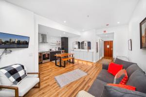a living room with a couch and a table at Modern Studio at Blackcomb base in Whistler