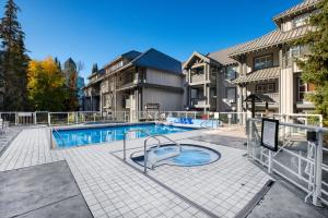 a swimming pool in the middle of a house at Modern Studio at Blackcomb base in Whistler +8 photos