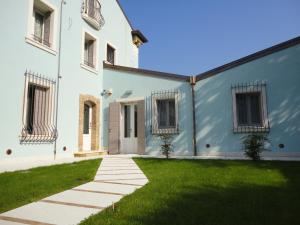 una casa bianca con un prato verde di Talamo Rooms a San Martino Buon Albergo