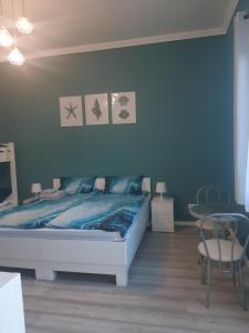 Posteľ alebo postele v izbe v ubytovaní Ta'karos apartman