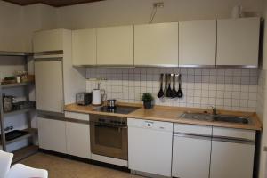 a kitchen with white cabinets and a sink at Sandsteinhaus mit Garten im Naturpark Hassberge in Kirchlauter