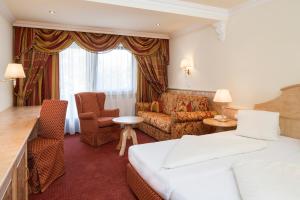 Ein Bett oder Betten in einem Zimmer der Unterkunft Hotel Jenbacherhof B&B