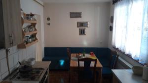 a small kitchen with a table and a blue couch at Apartman Oasis 2 Ilidza in Sarajevo +37 photos