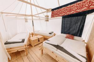 a bedroom with two beds and a canopy at Malešov Camp in Malešov
