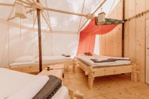 a room with two beds and a tent at Malešov Camp in Malešov