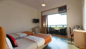 Postel nebo postele na pokoji v ubytování Sea Green Hotel