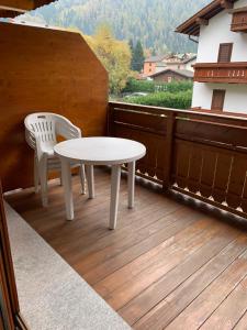 a white table and two chairs on a balcony at Monolocale Campodolcino in Campodolcino