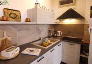 a small kitchen with a sink and a stove at Casa della Nina in Pigra