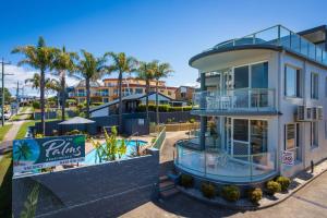 a building with a pool and a resort at The Palms Apartments in Merimbula