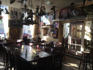 a restaurant with a large wooden table and chairs at Hotel de Blauwe Vogel in Bergen op Zoom