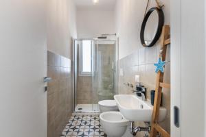 a bathroom with a sink and a toilet and a shower at Margló in Avola +13 photos