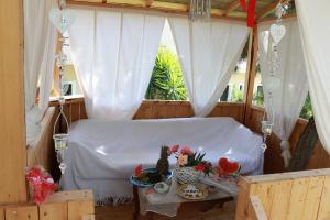 a room with a table and a window with white curtains at Gongis Studios in Agios Georgios