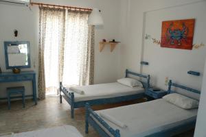 a room with two beds and a window at Gongis Studios in Agios Georgios
