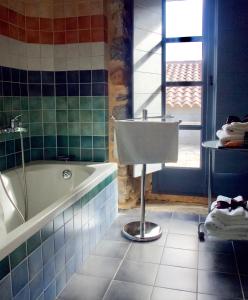 a bathroom with a bath tub and a sink at Astra hotel in Kastanéa