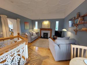a living room with a couch and a fireplace at 1 Bed Lodge - Sleeps 2 - Parking - Wifi in Acharacle +3 photos
