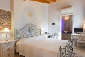 a bedroom with a bed and a table and a television at Talamo Rooms in San Martino Buon Albergo