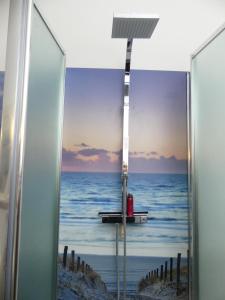 a glass door with a view of the ocean at Ferienhaus Strandlust in Butjadingen