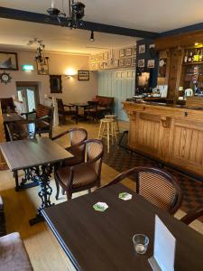 a restaurant with tables and chairs and a bar at The Acres B&B in Killala