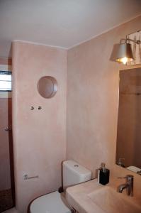 uma casa de banho com um WC, um lavatório e um espelho. em Chez Semiramis Aegean Pearl House for 8 persons 5'min from the beach em Serifos Chora