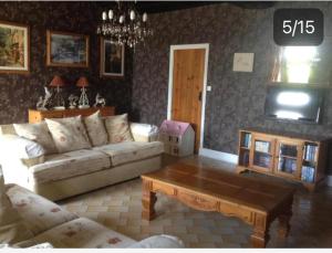 a living room with a couch and a coffee table at Le Bois derre gite in Éancé