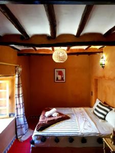 a bedroom with a bed with a towel on it at Dar Isselday in Tisselday