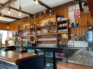 a bar with a counter and a shelf of alcohol at The Banks Of Ury in Inverurie
