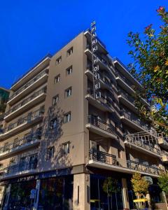 a tall building with a sign on the side of it at Hotel Park in Larisa