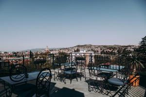 a group of chairs and tables on a balcony at Hotel Winoterra in Tbilisi City
