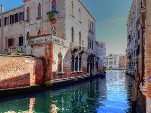 a canal between two buildings in a city at BAROCCO-Veneziano in Venice