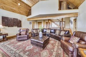 a living room with leather furniture and a rug at Highfield Trail home in Breckenridge