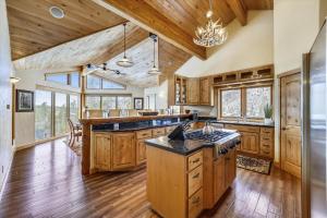 a large kitchen with wooden cabinets and a large island at Highfield Trail home in Breckenridge +50 photos